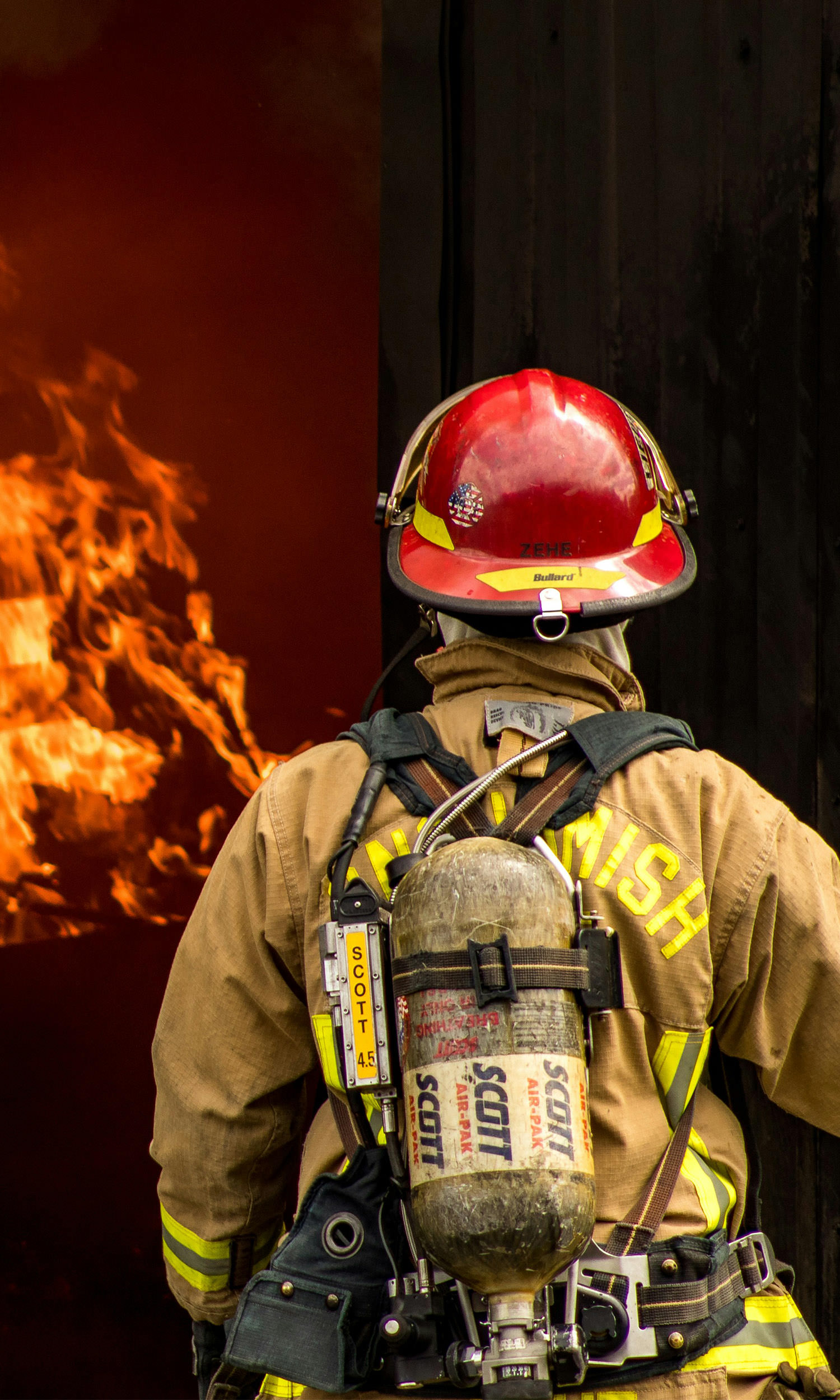 firefighter preparing to enter burning building